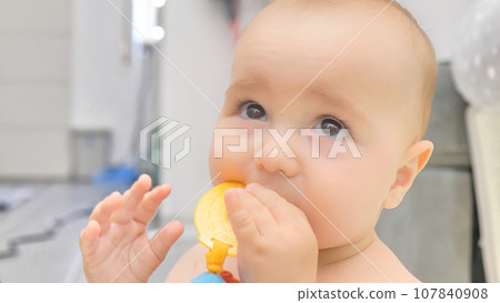 portrait of a child playing with a toy portrait of a child playing with a toy 107840908