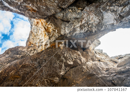 Prisojnik or Prisank Window. The larges rock window in Alps, Triglav National Park, Julian Alps, Slovenia 107841167