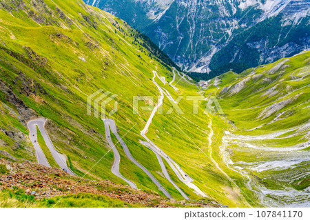 Stelvio pass serpentines. Asphalt road high in the Italian Alps, Italy Stelvio pass serpentines. Asphalt road high in the Italian Alps, Italy 107841170
