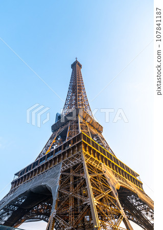Eiffel Tower bottom-up view in the sunny morning. Paris, France Eiffel Tower bottom-up view in the sunny morning. Paris, France 107841187