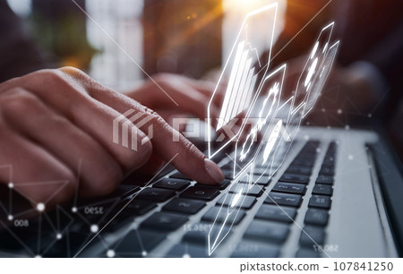 man's hands typing on laptop keyboard in interior man's hands typing on laptop keyboard in interior 107841250
