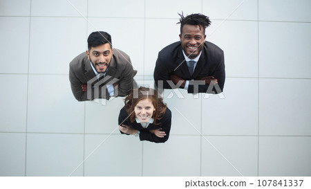 Top view of three business people looking up Top view of three business people looking up 107841337