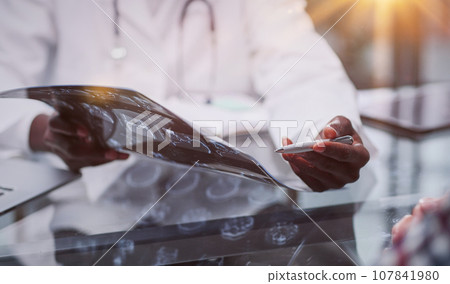 patient at a reception at the doctor looking an x-ray 107841980