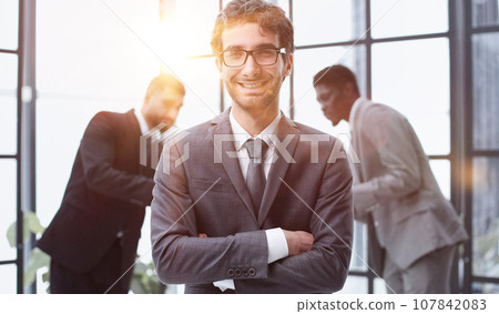 Young Confident Businessman Smiling at the Camera 107842083