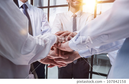 Close up on colleagues hands all together Close up on colleagues hands all together 107842158