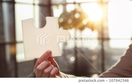 Business Woman holding two blank white puzzle Business Woman holding two blank white puzzle 107842566