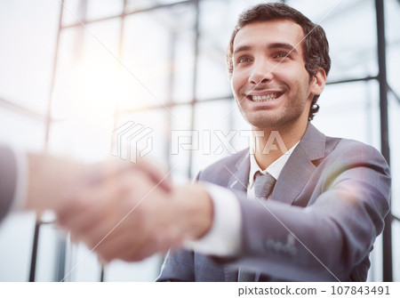 close up.businessman shaking hands with his business partner close up.businessman shaking hands with his business partner 107843491