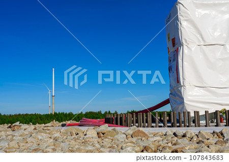 Installing First Heavy Components on Concrete Foundation for Future Wind Turbine 107843683