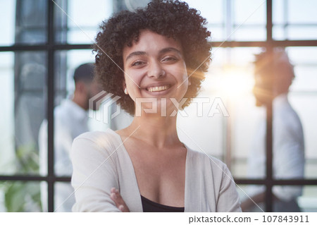 business woman with her staff in background at office 107843911