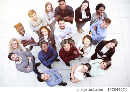 large group of diverse young people looking up hopefully 107844074