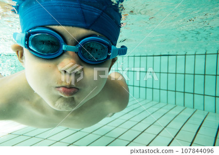 Elementary school students swimming in the pool Elementary school students swimming in the pool 107844096