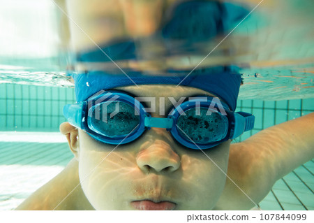 Elementary school students swimming in the pool Elementary school students swimming in the pool 107844099