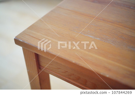 A 4-seater dining table that has been used for over 10 years. 107844269