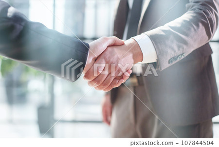 Business shaking hands, finishing up meeting. Successful businessmen handshaking after good deal. Business shaking hands, finishing up meeting. Successful businessmen handshaking after good deal. 107844504