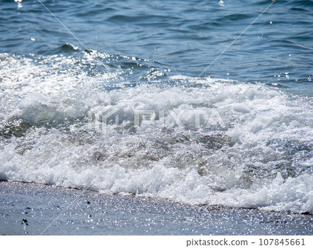 Waves crashing against the beach. Waves crashing against the beach. 107845661