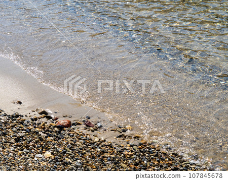 The beach on the sandy beach of the transparent and beautiful sea. The beach on the sandy beach of the transparent and beautiful sea. 107845678