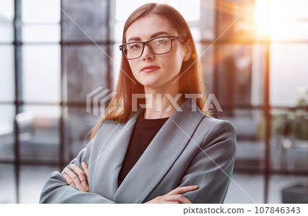 Dream big and make it happen. Portrait of a confident young businesswoman standing with her arms crossed in an office. Dream big and make it happen. Portrait of a confident young businesswoman standing with her arms crossed in an office. 107846343