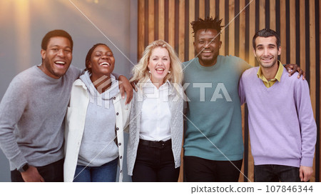 Business team consisting of young business people standing side by side Business team consisting of young business people standing side by side 107846344