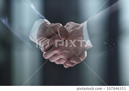 Close-up image of handshake between two colleagues. Close-up image of handshake between two colleagues. 107846351