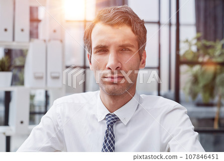 Confident young businessman posing in the office 107846451