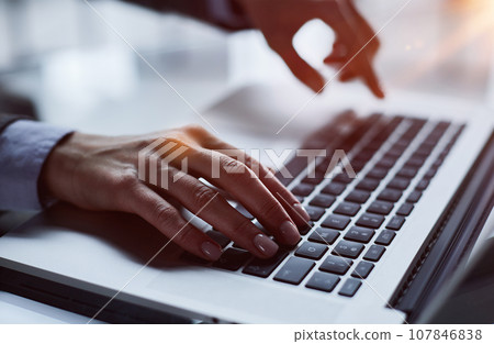 Close-up of male hands using laptop at office 107846838