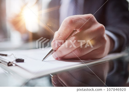 Hand makes notes on a paper notebook, close-up Hand makes notes on a paper notebook, close-up 107846920