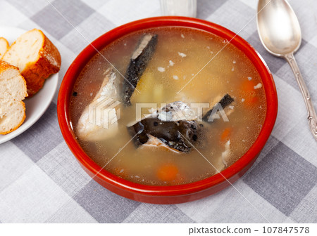 Salmon head soup with potatoes and carrots in clay bowl Salmon head soup with potatoes and carrots in clay bowl 107847578