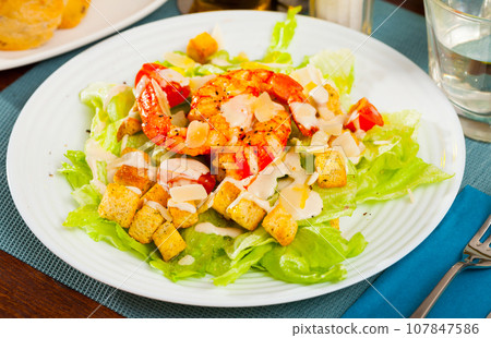 Caesar salad with shrimps, lettuce, sauce and cheese, nobody 107847586