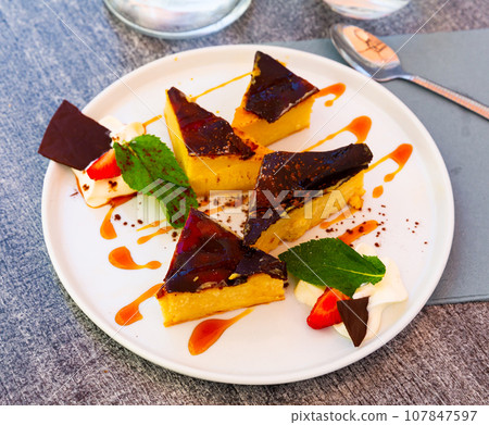 Custard tart on white plate, french cuisine Custard tart on white plate, french cuisine 107847597