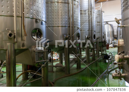 Interior of winery with stainless steel tanks Interior of winery with stainless steel tanks 107847836