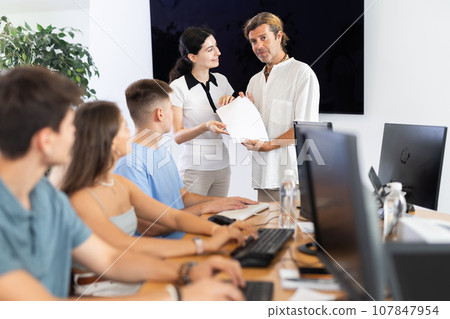 Among students of computer courses, male teacher awards diploma and to excellent girl pupil 107847954
