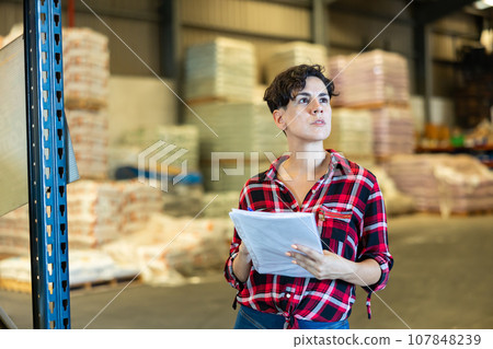 Woman making stock control in warehouse Woman making stock control in warehouse 107848239