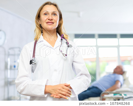 Adult woman doctor posing in medical office Adult woman doctor posing in medical office 107848268