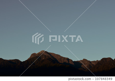 Mt. Kaikomagatake in the Southern Alps, Nagasaka Town, Hokuto, the top of which is dyed red by the morning sun 107848349