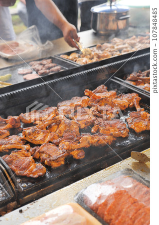 Beef and chicken steaks on the grill with flames. Beef and chicken steaks on the grill with flames. 107848485