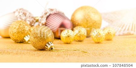 Pile of bright Christmas gold baubles. Christmas spirit. Pile of bright Christmas gold baubles. Christmas spirit. 107848504