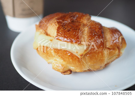 fresh baked croissant on plate with copy space fresh baked croissant on plate with copy space 107848505