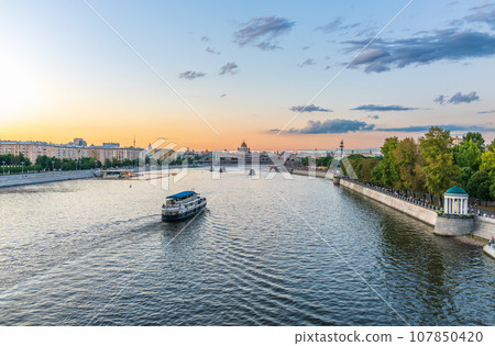 Cruise ship sails on the Moscow river in Moscow city center, popular place for walking. 107850420