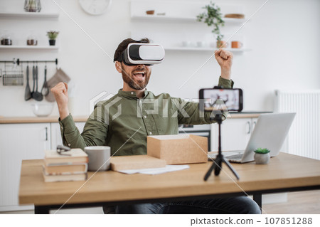 Smartphone recording video of blogger testing VR headset Smartphone recording video of blogger testing VR headset 107851288