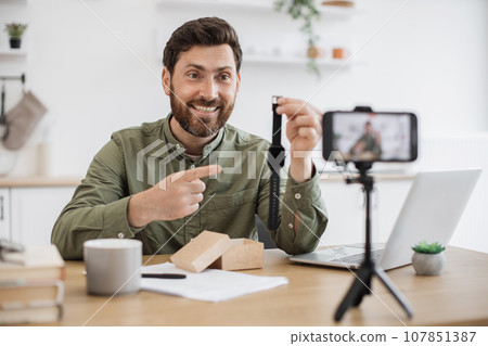 Man advertising new watch during video record on smartphone Man advertising new watch during video record on smartphone 107851387