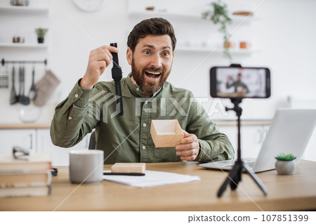 Man advertising new watch during video record on smartphone 107851399