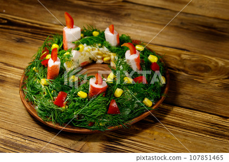 Salad Christmas wreath on a wooden table Salad Christmas wreath on a wooden table 107851465
