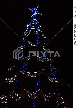 Decorated Christmas tree with multi-colored lights at night Decorated Christmas tree with multi-colored lights at night 107851473