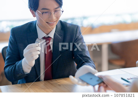 Purchasing specialist who appraises used IPHONEs 107851821