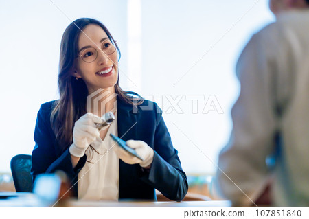 Purchaser appraising smartphones Purchaser appraising smartphones 107851840