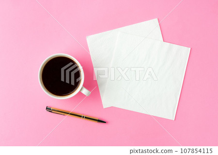 Coffee cup with paper napkins on pink background 107854115