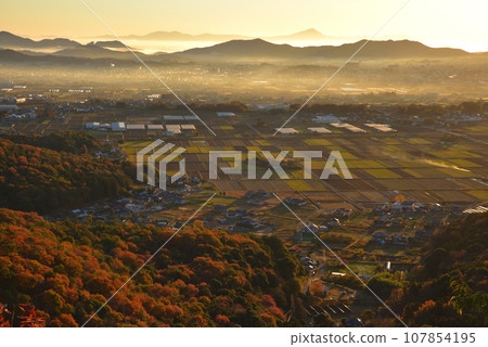 View of the foot of Mt. Okoyama, Mt. Mibo, and the distant direction of Mt. Tsukuba at dawn from the small peak on the south side of Mt. Okoyama in late autumn. 107854195