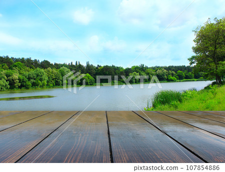 wooden boards with view to forest lake wooden boards with view to forest lake 107854886