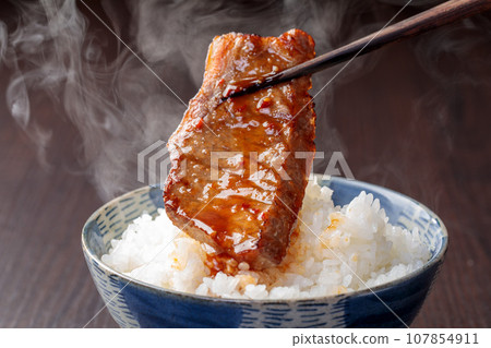 Scene of eating grilled meat and hot rice together Scene of eating grilled meat and hot rice together 107854911