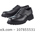 Amazing pair of men's derby boots made of pimpled dense black leather with lacing, on a high powerful sole, isolated on a white background. 107855531